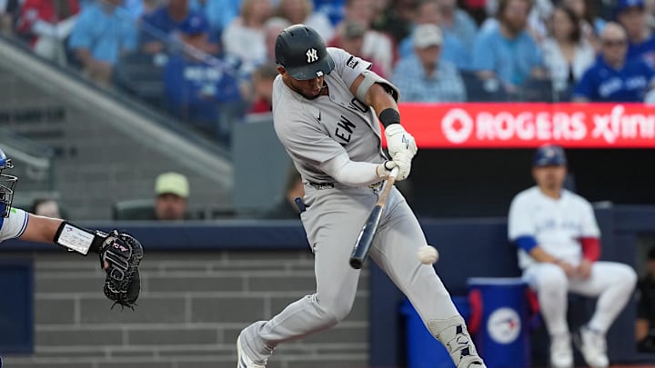 Jul 21, 2025; Toronto, Ontario, CAN; New York Yankees third baseman Oswald Peraza (18) hits a single against the Toronto Blue Jays during the fifth inning at Rogers Centre. Mandatory Credit: Nick Turchiaro-Imagn Images Jul 21, 2025; Toronto, Ontario, CAN; New York Yankees third baseman Oswald Peraza (18) hits a single against the Toronto Blue Jays during the fifth inning at Rogers Centre. Mandatory Credit: Nick Turchiaro-Imagn Images