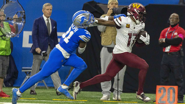 Jan 18, 2025; Detroit, Michigan, USA; Washington Commanders wide receiver Terry McLaurin (17) runs the ball against Detroit Lions safety Kerby Joseph (31)  during the second quarter at Ford Field.
