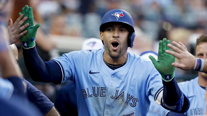 Jul 26, 2025; Detroit, Michigan, USA;  Toronto Blue Jays outfielder George Springer (4) receives congratulations from teammates after he hits a home run in the ninth inning against the Detroit Tigers at Comerica Park. 