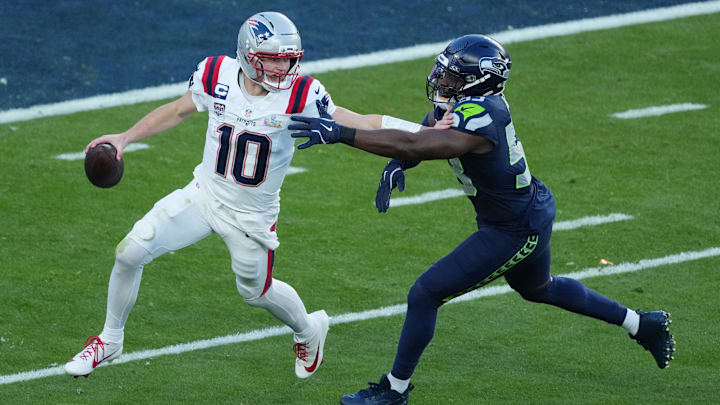 Feb 8, 2026; Santa Clara, CA, USA; New England Patriots quarterback Drake Maye (10) is pressured by Seattle Seahawks linebacker Boye Mafe (53) in the first half in Super Bowl LX at Levi's Stadium.