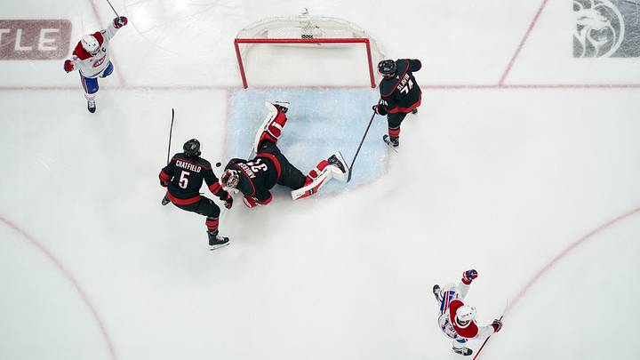 May 21, 2026; Raleigh, North Carolina, USA; Montreal Canadiens center Nick Suzuki (14) and right wing Cole Caufield (13) celebrate a goal against Carolina Hurricanes goaltender Frederik Andersen (31) by center Phillip Danault (not pictured) during the first period in game one of the Eastern Conferene Final of the 2026 Stanley Cup Playoffs at Lenovo Center. Mandatory Credit: James Guillory-Imagn Images