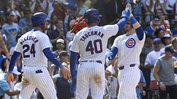 Jun 15, 2024; Chicago, Illinois, USA; Chicago Cubs outfielder Ian Happ (8), right, high fives outfielder Cody Bellinger (24) and outfielder Mike Tauchman (40) after they score on Happ’s three run home run during the seventh inning at Wrigley Field. Jun 15, 2024; Chicago, Illinois, USA; Chicago Cubs outfielder Ian Happ (8), right, high fives outfielder Cody Bellinger (24) and outfielder Mike Tauchman (40) after they score on Happ’s three run home run during the seventh inning at Wrigley Field.