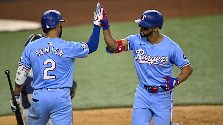 Sep 22, 2024; Arlington, Texas, USA; Texas Rangers third baseman Ezequiel Duran (20) and second baseman Marcus Semien (2) celebrate after Duran hits a home run against the Seattle Mariners during the seventh inning at Globe Life Field.