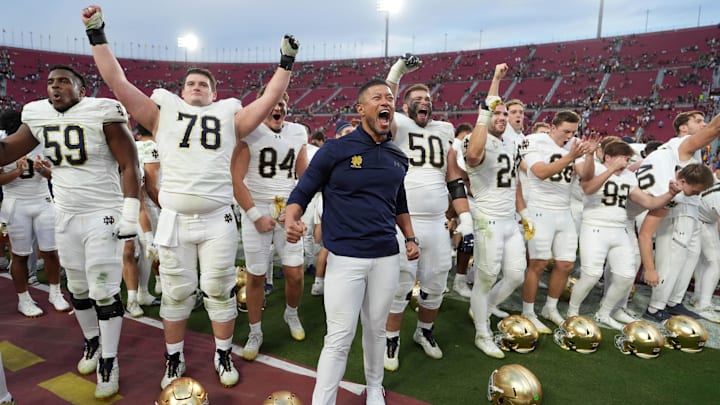 Nov 30, 2024; Los Angeles, California, USA; Notre Dame Fighting Irish head coach Marcus Freeman celebrates with players at the end of the game against the Southern California Trojans at United Airlines Field at Los Angeles Memorial Coliseum. 
