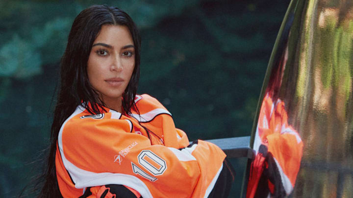 Kim Kardashian was photographed by Greg Swales in the Dominican Republic. Swimsuit by SKIMS. Top by Balenciaga. Gloves by Fox. 