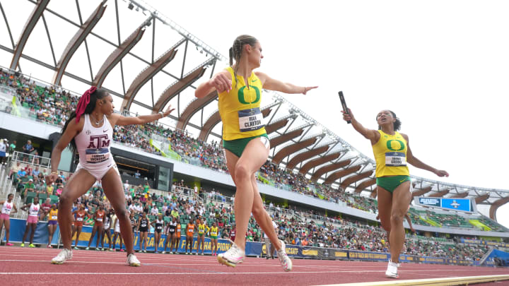 Jun 8, 2024; Eugene, OR, USA; Ella Clayton takes the handoff from Shana Grebo on the second leg of the Oregon Ducks women's 4 x 400m relay during the NCAA Track and Field Championships at Hayward Field. Mandatory Credit: Kirby Lee-USA TODAY Sports