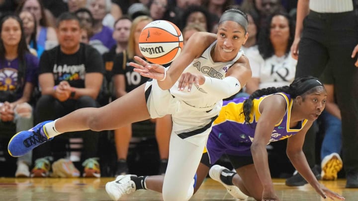 Jul 5, 2024; Los Angeles, California, USA; Las Vegas Aces center A'ja Wilson (22) passes the ball against LA Sparks guard Aari McDonald (15) in the first half at Crypto.com Arena. Mandatory Credit: Kirby Lee-USA TODAY Sports