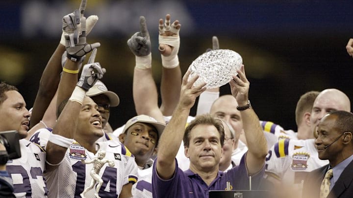 Jan. 4, 2004; New Orleans, LA, USA; Nick Saban, in blue, lifts the BCS National Championship Trophy after the Tigers' 21-14 victory over Oklahoma in the Nokia Sugar Bowl; Mandatory credit: Robert Deutsch-USA TODAY NETWORK