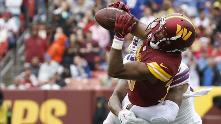 Washington Commanders cornerback Kendall Fuller intercepts a pass intended for Buffalo Bills wide receiver Gabe Davis.