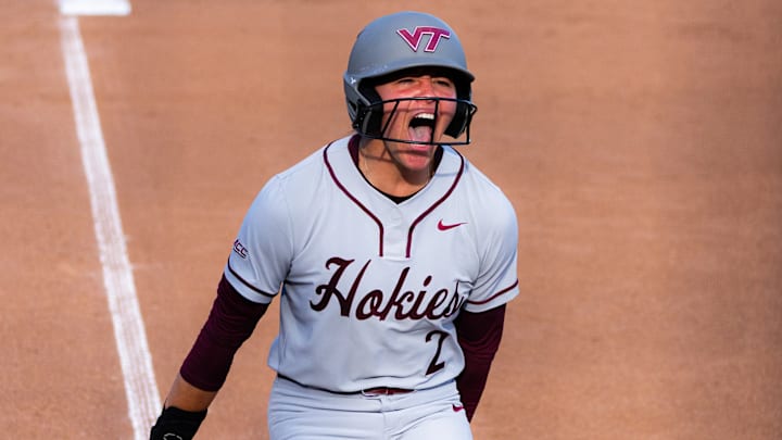 Cori McMillan is fired up after a home run, running down the third base line with excitement. 