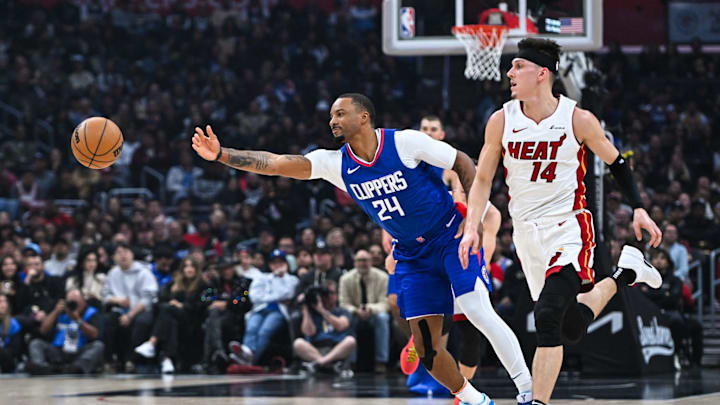 Jan 1, 2024; Los Angeles, California, USA; Los Angeles Clippers guard Norman Powell (24) passes the ball against Miami Heat guard Tyler Herro (14) during the first quarter at Crypto.com Arena. Mandatory Credit: Jonathan Hui-Imagn Images Jan 1, 2024; Los Angeles, California, USA; Los Angeles Clippers guard Norman Powell (24) passes the ball against Miami Heat guard Tyler Herro (14) during the first quarter at Crypto.com Arena. Mandatory Credit: Jonathan Hui-Imagn Images