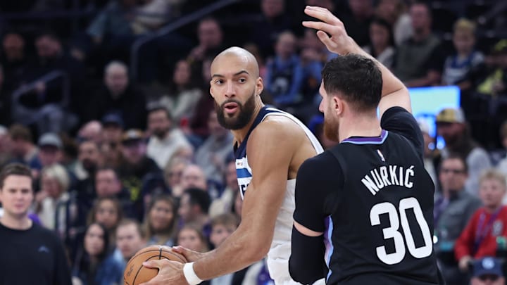 Jan 20, 2026; Salt Lake City, Utah, USA; Minnesota Timberwolves center Rudy Gobert (27) looks to pass against Utah Jazz center Jusuf Nurkic (30) during the second half at Delta Center. Mandatory Credit: Rob Gray-Imagn Images