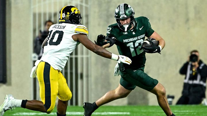 Michigan State's Jack Velling, right, runs after a catch as Iowa's Nick Jackson closes in during the third quarter on Saturday, Oct. 19, 2024, at Spartan Stadium in East Lansing.