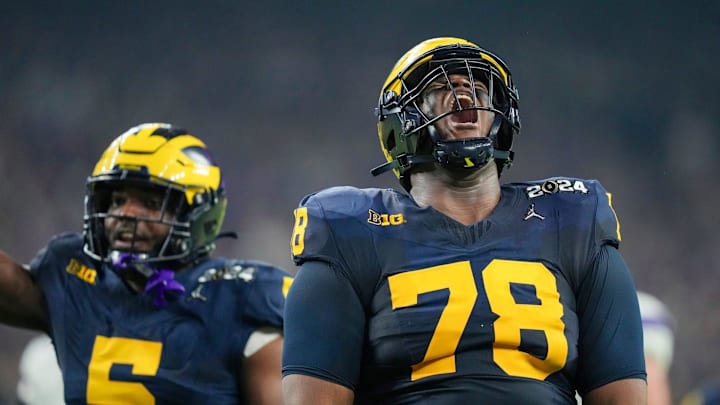 Michigan defensive lineman Kenneth Grant celebrates a sack on Washington quarterback Michael Penix Jr. during the College Football Playoff national championship game against Washington at NRG Stadium in Houston, Texas, on Monday, Jan. 8, 2024. Michigan defensive lineman Kenneth Grant celebrates a sack on Washington quarterback Michael Penix Jr. during the College Football Playoff national championship game against Washington at NRG Stadium in Houston, Texas, on Monday, Jan. 8, 2024.