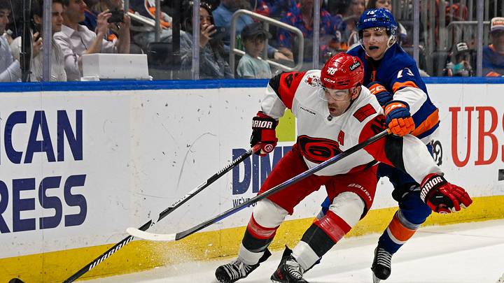 Apr 14, 2026; Elmont, New York, USA;  New York Islanders right wing Victor Eklund (73) defends against Carolina Hurricanes left wing Jordan Martinook (48) during the third period at UBS Arena. Mandatory Credit: Dennis Schneidler-Imagn Images