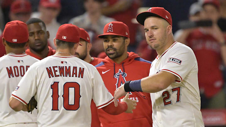 Jun 28, 2025; Anaheim, California, USA;  Los Angeles Angels right fielder Mike Trout (27) greets third baseman Kevin Newman (10) after the final out of the ninth inning defeating the Washington Nationals at Angel Stadium. Mandatory Credit: Jayne Kamin-Oncea-Imagn Images