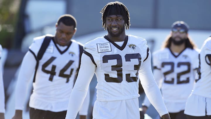 Jacksonville Jaguars linebacker Devin Lloyd (33) and teammates arrive at the practice fields for the training camp.