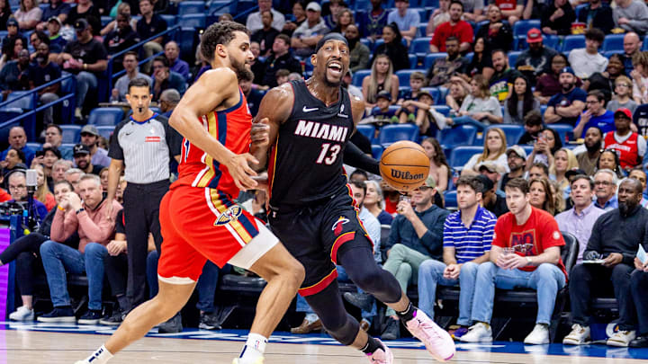 Apr 11, 2025; New Orleans, Louisiana, USA; Miami Heat center Bam Adebayo (13) dribbles against New Orleans Pelicans forward Jeremiah Robinson-Earl (50) during the first half at Smoothie King Center. Mandatory Credit: Stephen Lew-Imagn Images