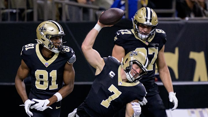 Nov 17, 2024; New Orleans, Louisiana, USA; New Orleans Saints tight end Taysom Hill (7) celebrates a touchdown with wide receiver Kevin Austin Jr. (81) and tight end Foster Moreau (87) in the first quarter against the Cleveland Browns at Caesars Superdome. Mandatory Credit: Matthew Hinton-Imagn Images Nov 17, 2024; New Orleans, Louisiana, USA; New Orleans Saints tight end Taysom Hill (7) celebrates a touchdown with wide receiver Kevin Austin Jr. (81) and tight end Foster Moreau (87) in the first quarter against the Cleveland Browns at Caesars Superdome. Mandatory Credit: Matthew Hinton-Imagn Images
