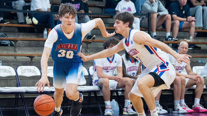 Indiana Junior All-Star Braylon Mullins (30) makes his way to the basket around Kentucky Junior All-Star Zander Carter (7) during their game on Sunday, June 2, 2024 in Scottsburg, Ind. at Charles E. Meyer Gymnasium for the first game of the Indiana vs Kentucky All-Stars basketball week.