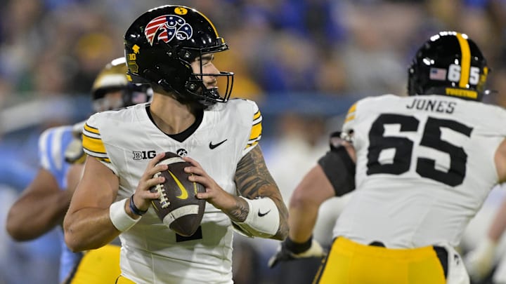 Nov 8, 2024; Pasadena, California, USA;   Iowa Hawkeyes quarterback Brendan Sullivan (1) sets to pass in the first half against the UCLA Bruins at the Rose Bowl. Mandatory Credit: Jayne Kamin-Oncea-Imagn Images