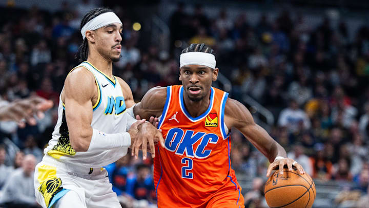 Dec 26, 2024; Indianapolis, Indiana, USA; Oklahoma City Thunder guard Shai Gilgeous-Alexander (2) dribbles the ball while Indiana Pacers guard Andrew Nembhard (2) defends in the second half at Gainbridge Fieldhouse. Mandatory Credit: Trevor Ruszkowski-Imagn Images Dec 26, 2024; Indianapolis, Indiana, USA; Oklahoma City Thunder guard Shai Gilgeous-Alexander (2) dribbles the ball while Indiana Pacers guard Andrew Nembhard (2) defends in the second half at Gainbridge Fieldhouse. Mandatory Credit: Trevor Ruszkowski-Imagn Images