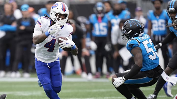 Oct 26, 2025; Charlotte, North Carolina, USA; Buffalo Bills running back James Cook III (4) scores a touchdown against Carolina Panthers linebacker Claudin Cherelus (53) during the second half at Bank of America Stadium. 