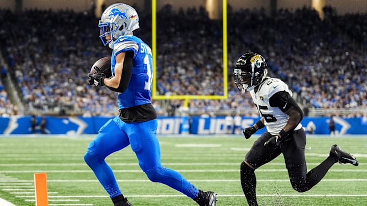 Detroit Lions wide receiver Amon-Ra St. Brown (14) makes a catch in the end zone for a touchdown against Jacksonville Jaguars cornerback Ronald Darby (25) during the second half at Ford Field in Detroit on Sunday, Nov. 17, 2024.