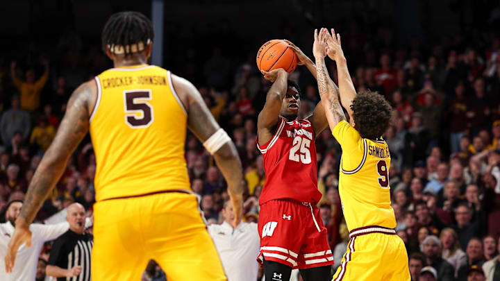 Jan 13, 2026; Minneapolis, Minnesota, USA; Wisconsin Badgers guard John Blackwell (25) shoots the game winning shot as Minnesota Golden Gophers guard Kai Shinholster (9) defends during the second half at Williams Arena. 