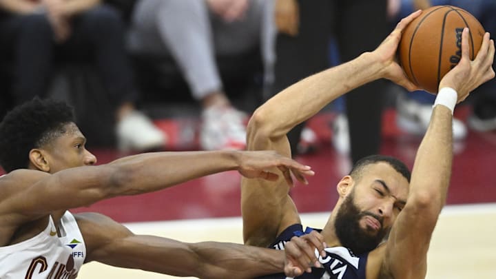 Minnesota Timberwolves center Rudy Gobert rebounds beside Cleveland Cavaliers forward De'Andre Hunter in the fourth quarter at Rocket Mortgage FieldHouse in Cleveland on Feb. 10, 2025.