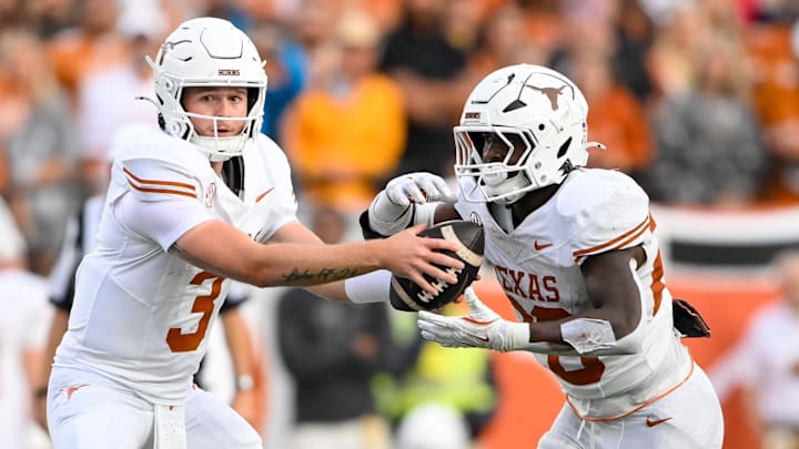 Oct 26, 2024; Nashville, Tennessee, USA;  Texas Longhorns quarterback Quinn Ewers (3) hands the ball off to running back Quintrevion Wisner (26) against the Vanderbilt Commodores during the second half at FirstBank Stadium. Mandatory Credit: Steve Roberts-Imagn Images