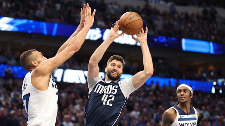 Dallas Mavericks forward Maxi Kleber passes the ball as Minnesota Timberwolves center Rudy Gobert defends during the fourth quarter of Game 4 of the Western Conference finals at American Airlines Center in Dallas on May 28, 2024.