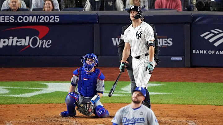 Oct 30, 2024; New York, New York, USA; New York Yankees designated hitter Giancarlo Stanton (27) hits a solo home run off of Los Angeles Dodgers pitcher Ryan Brasier (57) during the third inning in game four of the 2024 MLB World Series at Yankee Stadium. Mandatory Credit: Robert Deutsch-Imagn Images