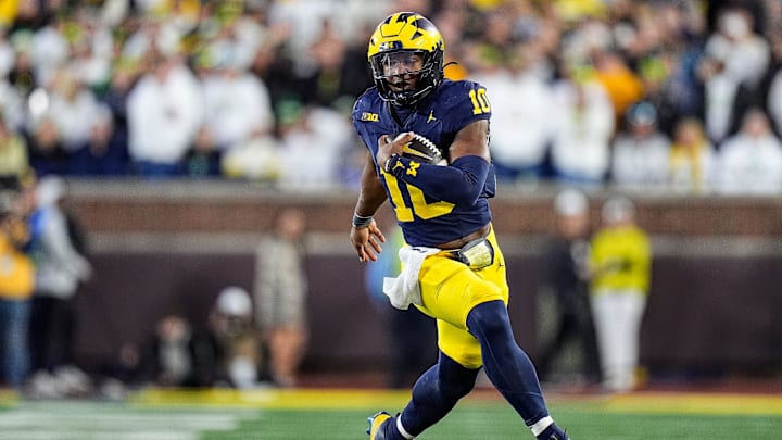 Michigan quarterback Alex Orji runs against Oregon during the second half at Michigan Stadium.