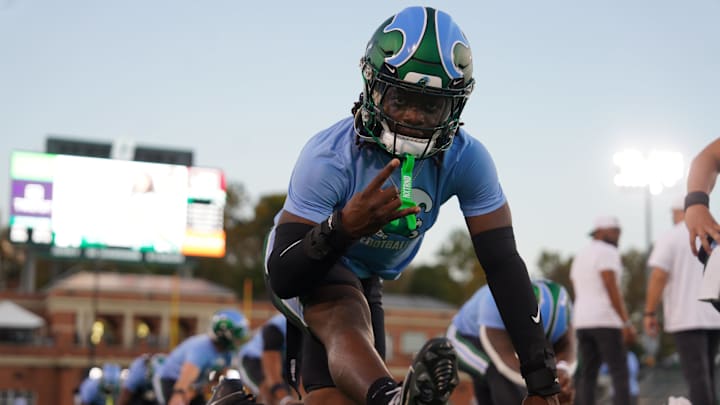 A Tulane Green Wave players stretches for a game against the Charlotte 49ers. A Tulane Green Wave players stretches for a game against the Charlotte 49ers.