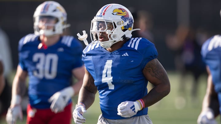 Kansas redshirt senior running back Leshon Williams (4) runs to positions during an outdoor practice on Thursday, March 27, 2025.