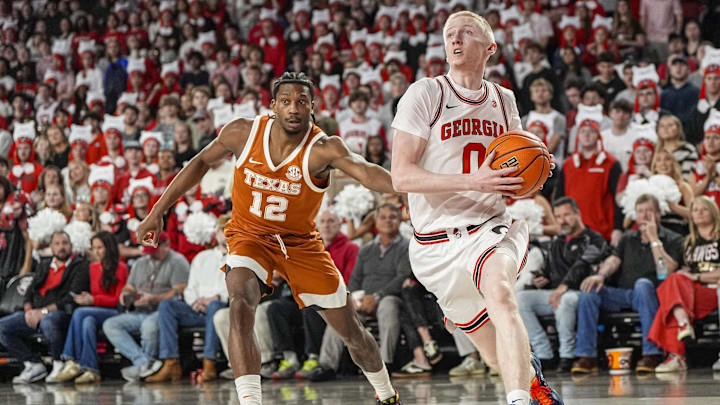 Feb 21, 2026; Athens, Georgia, USA; Georgia Bulldogs guard Blue Cain (0) drives to the basket past Texas Longhorns guard Tramon Mark (12) during the first half at Stegeman Coliseum. Mandatory Credit: Dale Zanine-Imagn Images