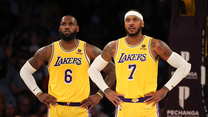 Nov 26, 2021; Los Angeles, California, USA; Los Angeles Lakers forward LeBron James (6) and forward Carmelo Anthony (7) stand on the court during the game against the Sacramento Kings at Staples Center. The Kings wins 141-137 in the triple-overtime. Mandatory Credit: Kiyoshi Mio-Imagn Images