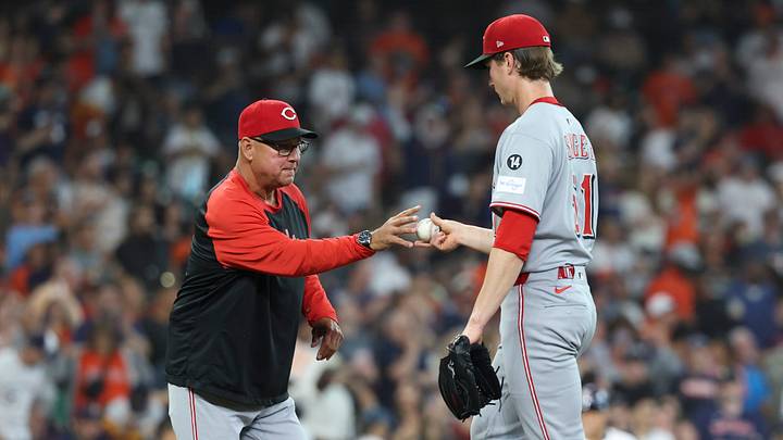 May 10, 2025; Houston, Texas, USA; Cincinnati Reds starting pitcher Brady Singer (51) hands the ball to manager Terry Francona (77) during a pitching change in the third inning against the Houston Astros at Daikin Park. Mandatory Credit: Troy Taormina-Imagn Images