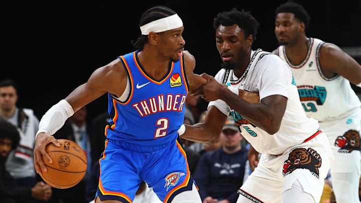 Feb 8, 2025; Memphis, Tennessee, USA; Oklahoma City Thunder guard Shai Gilgeous-Alexander (2) dribbles as Memphis Grizzlies guard Vince Williams Jr. (5) defends during the third quarter at FedExForum. Mandatory Credit: Petre Thomas-Imagn Images