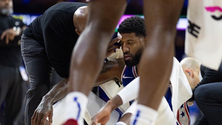 Nov 10, 2024; Philadelphia, Pennsylvania, USA; Philadelphia 76ers forward Paul George (8) is tended to after an apparent collision during the first quarter against the Charlotte Hornets at Wells Fargo Center. Mandatory Credit: Bill Streicher-Imagn Images