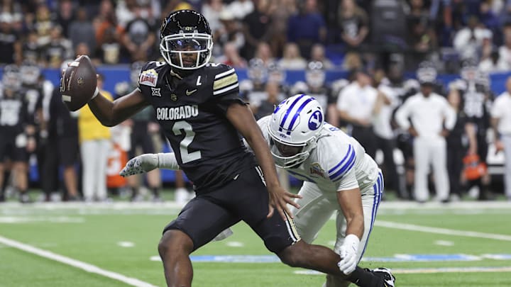 Dec 28, 2024; San Antonio, TX, USA; Colorado Buffaloes quarterback Shedeur Sanders (2) attempts to avoid a tackle by Brigham Young Cougars safety Raider Damuni (3) during the second quarter at Alamodome. Mandatory Credit: Troy Taormina-Imagn Images Dec 28, 2024; San Antonio, TX, USA; Colorado Buffaloes quarterback Shedeur Sanders (2) attempts to avoid a tackle by Brigham Young Cougars safety Raider Damuni (3) during the second quarter at Alamodome. Mandatory Credit: Troy Taormina-Imagn Images