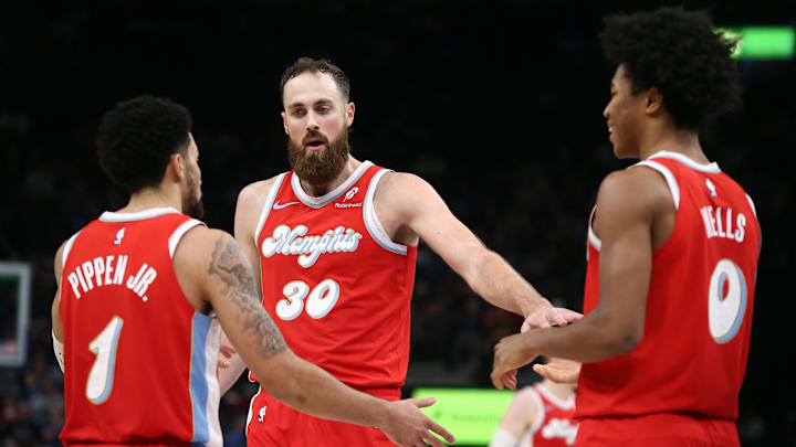 Nov 17, 2024; Memphis, Tennessee, USA; Memphis Grizzlies center Jay Huff (30) reacts with guard Scotty Pippen Jr. (1) and forward Jaylen Wells (0) during the second half against the Denver Nuggets at FedExForum. Mandatory Credit: Petre Thomas-Imagn Images