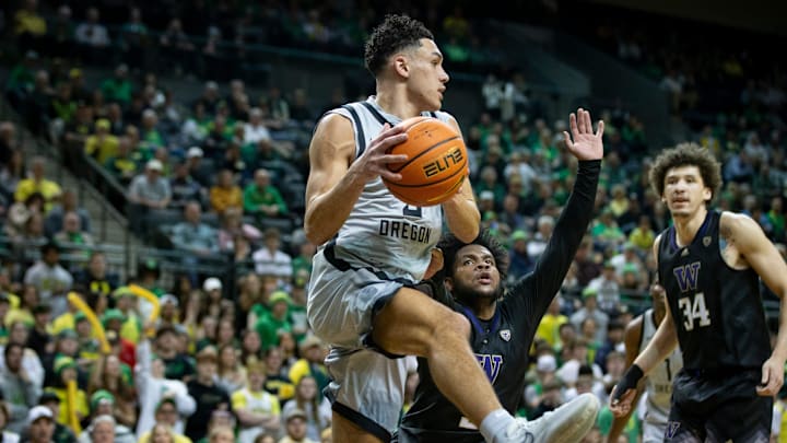 Oregon guard Jackson Shelstad leaps along the baseline as the Oregon Ducks host Washington.