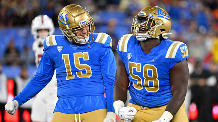 Oct 29, 2022; Pasadena, California, USA;  UCLA Bruins linebacker Laiatu Latu (15) and defensive lineman Gary Smith III (58) celebrate after a sack of Stanford Cardinal quarterback Tanner McKee (18)  in the first half at the Rose Bowl. Mandatory Credit: Jayne Kamin-Oncea-Imagn Images