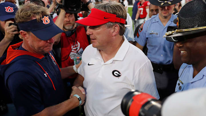 Auburn head coach Hugh Freeze and Georgia head coach Kirby Smart shake hands after a NCAA college football game in Athens, Ga., on Saturday, Oct. 5, 2024.