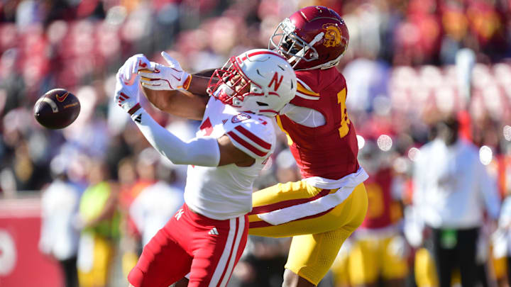 Nov 16, 2024; Los Angeles, California, USA; Nebraska Cornhuskers defensive back Malcolm Hartzog Jr. (7) breaks up a pass intended for Southern California Trojans wide receiver Kyron Hudson (10) during the first half at the Los Angeles Memorial Coliseum. 
