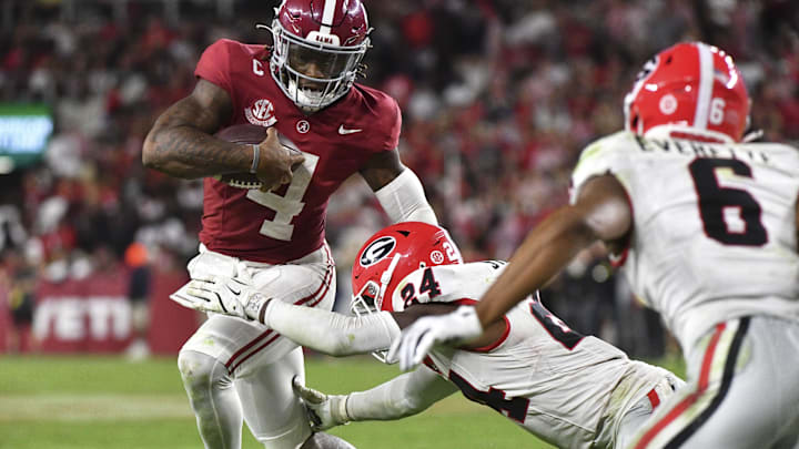 Sep 28, 2024; Tuscaloosa, Alabama, USA;  Georgia Bulldogs defensive back Malaki Starks (24) tackles Alabama Crimson Tide quarterback Jalen Milroe (4) at Bryant-Denny Stadium. Alabama defeated Georgia 41-34. Mandatory Credit: Gary Cosby Jr.-Imagn Images