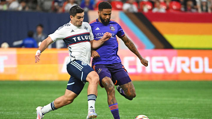 Houston Dynamo FC defender Micael dos Santos (31) and Vancouver Whitecaps FC forward Brian White (24) collide during the second half at BC Place 