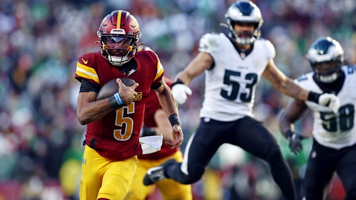 Washington Commanders quarterback Jayden Daniels runs the ball against the Philadelphia Eagles during the third quarter at Northwest Stadium.